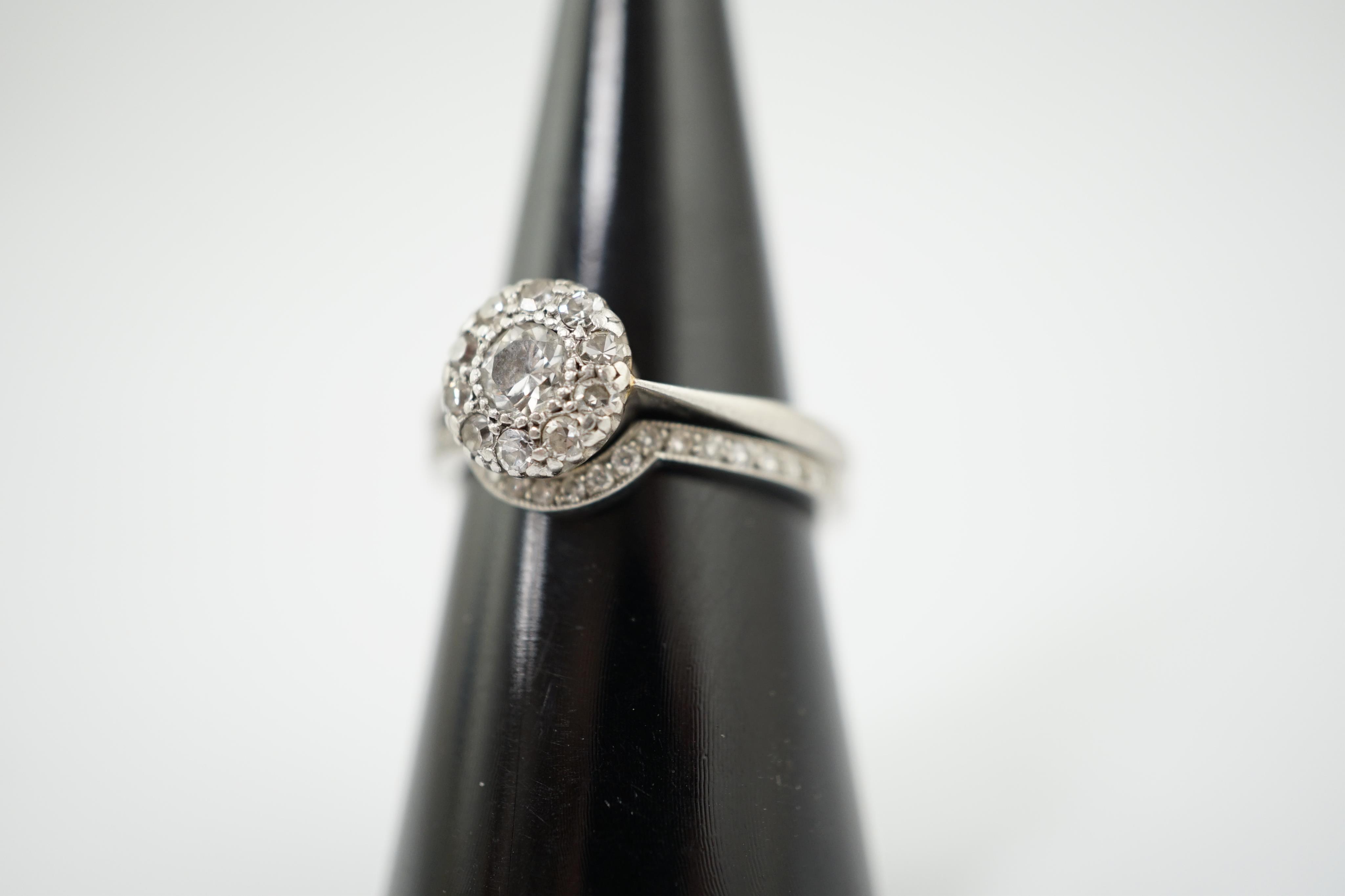 A mid 20th century and later platinum and diamond matched two piece wedding set